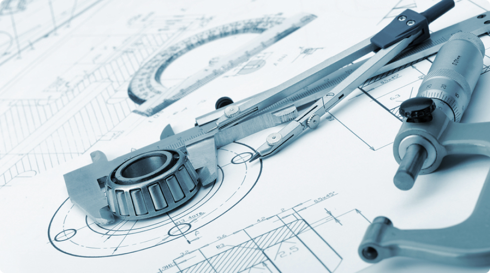 A group of tools and blueprints on a table.